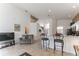 Bright, open-concept living area featuring tile flooring and neutral walls with staircase at 149 Emeraldview Ave, Davenport, FL 33897