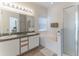 Bright main bathroom with double sinks, a soaking tub, and a separate shower stall at 149 Emeraldview Ave, Davenport, FL 33897