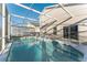 Large screened in pool with lounge chairs provides the perfect outdoor oasis at 149 Emeraldview Ave, Davenport, FL 33897