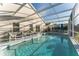 Relaxing screened in pool area with plenty of seating for enjoying the outdoors at 149 Emeraldview Ave, Davenport, FL 33897