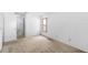 Bedroom featuring carpet and natural light from a window, with access to bathroom at 171 Seabreeze Cir, Kissimmee, FL 34743