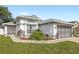 Charming single-story home featuring a well-manicured lawn and beautiful landscaping that frames the facade at 171 Seabreeze Cir, Kissimmee, FL 34743