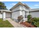 Inviting front entrance of home featuring mature landscaping and a well-lit walkway at 171 Seabreeze Cir, Kissimmee, FL 34743