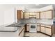 Functional kitchen featuring white appliances, neutral cabinetry, and tile floors at 171 Seabreeze Cir, Kissimmee, FL 34743