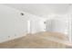Open floor plan featuring neutral carpet, bright lighting, and plenty of wall space at 171 Seabreeze Cir, Kissimmee, FL 34743