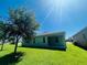 Expansive backyard with lush green lawn and mature trees, perfect for outdoor activities at 1726 Brassie Ct, Kissimmee, FL 34746