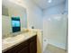Bathroom featuring a vanity with granite countertop and a glass-enclosed tiled shower at 1726 Brassie Ct, Kissimmee, FL 34746