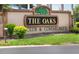 Welcoming entrance to The Oaks Club & Community with manicured landscaping at 1726 Brassie Ct, Kissimmee, FL 34746
