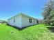 Spacious backyard featuring lush green grass and partial exterior of the house at 1726 Brassie Ct, Kissimmee, FL 34746