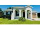 Inviting single-Gathering home featuring an arched entryway, a two-car garage, and verdant lawn at 1726 Brassie Ct, Kissimmee, FL 34746