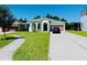Charming single-story home with a well-manicured lawn and a concrete driveway leading to a two-car garage at 1726 Brassie Ct, Kissimmee, FL 34746