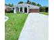 Charming single-story home with well-maintained lawn and long driveway at 1726 Brassie Ct, Kissimmee, FL 34746
