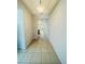Bright hallway with tile flooring leads to the kitchen area providing clear sightlines throughout the home at 1726 Brassie Ct, Kissimmee, FL 34746