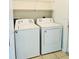 Efficient laundry space featuring a white washer and dryer and storage shelf at 1726 Brassie Ct, Kissimmee, FL 34746