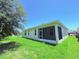 Relaxing screened patio with lush green grass surrounding the exterior of the home at 1726 Brassie Ct, Kissimmee, FL 34746