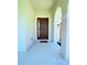 Inviting entryway featuring a contemporary brown front door and neutral decor at 1726 Brassie Ct, Kissimmee, FL 34746