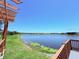 Scenic view of the lake from the community dock, with lake weeds along shoreline at 1726 Brassie Ct, Kissimmee, FL 34746