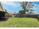Large, grassy backyard enclosed by a wooden fence, offering plenty of space for recreation and play at 1825 Needham Rd, Apopka, FL 32712