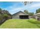 Backyard with green grass, wooden fence, and a screened in patio at 1825 Needham Rd, Apopka, FL 32712