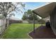 Spacious backyard with a covered patio area, perfect for outdoor entertaining and relaxation at 1825 Needham Rd, Apopka, FL 32712