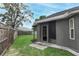 Well-maintained backyard featuring green grass, a privacy fence, and access to the home via a glass door at 1825 Needham Rd, Apopka, FL 32712