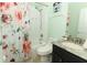 Bright bathroom features a shower and tub, granite counters, and a floral shower curtain at 1825 Needham Rd, Apopka, FL 32712