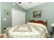 Bedroom features a ceiling fan, a closet, and light green walls at 1825 Needham Rd, Apopka, FL 32712