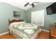 Bedroom features a ceiling fan, a window, and light green walls at 1825 Needham Rd, Apopka, FL 32712