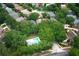 Aerial view showcases a home nestled within a lush, tree-lined neighborhood, near a community pool at 1825 Needham Rd, Apopka, FL 32712