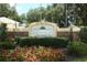 Cambridge Commons community sign with brick accents, landscaping, and colorful flowers, offering a warm welcome at 1825 Needham Rd, Apopka, FL 32712