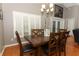 Inviting dining room with wood floors, plantation shutters, and a dark wood dining table with padded chairs at 1825 Needham Rd, Apopka, FL 32712