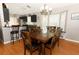 Open dining room area is adjacent to kitchen and boasts dark wood dining table with padded chairs and a bay window seat at 1825 Needham Rd, Apopka, FL 32712