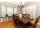 Charming dining room with a cozy window seat, wood floors, and a dark wood dining table with chairs at 1825 Needham Rd, Apopka, FL 32712
