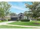 Charming single-story home with a well-manicured lawn and a two-car garage, showcasing lovely curb appeal at 1825 Needham Rd, Apopka, FL 32712