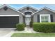 Close up of the front of the house showing the door and trimmed hedges at 1825 Needham Rd, Apopka, FL 32712