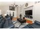 Spacious living room with a soaring ceiling, ceiling fan, and comfortable blue leather furniture at 1825 Needham Rd, Apopka, FL 32712