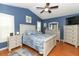 Serene main bedroom boasts beautiful blue walls, a ceiling fan, and white wood furniture at 1825 Needham Rd, Apopka, FL 32712