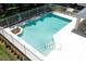 Inviting community pool area with clear blue water, surrounded by a white fence and ample deck space at 1825 Needham Rd, Apopka, FL 32712