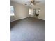 Spacious bedroom featuring neutral colored walls, ceiling fan, and connecting bathroom at 1880 N Crystal Lake Dr # 3, Lakeland, FL 33801