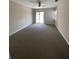 This bedroom features neutral walls, carpeted floors, and sliding glass door access at 1880 N Crystal Lake Dr # 3, Lakeland, FL 33801