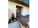 Inviting front door with welcome mat and decorative wreath, complemented by a charming wooden walkway and lush greenery at 1880 N Crystal Lake Dr # 3, Lakeland, FL 33801