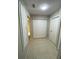 Bright hallway featuring neutral tile flooring, a double-door closet and access to other rooms at 1880 N Crystal Lake Dr # 3, Lakeland, FL 33801