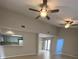 Spacious living area featuring tile floors, ceiling fans, and access to kitchen at 1880 N Crystal Lake Dr # 3, Lakeland, FL 33801