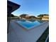 Community swimming pool surrounded by lounge chairs and nearby condos, under a blue sky at 1880 N Crystal Lake Dr # 3, Lakeland, FL 33801