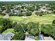 Aerial view of a home with a pool and golf course, in a lush green and peaceful neighborhood at 1969 Crystal Downs Ct, Oviedo, FL 32765