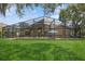 View of a beautiful screened in lanai, backyard, and pool area that is perfect for relaxation and entertainment at 1969 Crystal Downs Ct, Oviedo, FL 32765