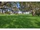 Beautiful backyard with a large manicured lawn with mature trees, perfect for outdoor activities at 1969 Crystal Downs Ct, Oviedo, FL 32765