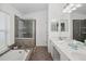 Well-appointed bathroom with a large soaking tub, separate glass shower, and double vanity at 1969 Crystal Downs Ct, Oviedo, FL 32765