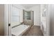 Bathroom features a soaking tub with shower and tiled flooring near the window at 1969 Crystal Downs Ct, Oviedo, FL 32765