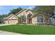 Charming home featuring a well-manicured lawn and beautiful landscaping, enhancing its curb appeal at 1969 Crystal Downs Ct, Oviedo, FL 32765
